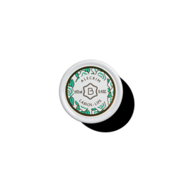 Moisturizing lip balm in a round container with a floral design. Available in various scents including Jacaranda, Laranjinha, Nata, Alecrim, Gordissimo, Alantoine, and Rose Amelie.
