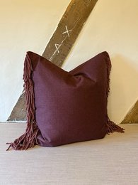 Decorative burgundy throw pillow with fringe, 50x50 cm in size, suitable for living room or bedroom decor.