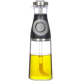 Glass oil container with dosing button, 500ml capacity, 9x31cm dimensions. Features stainless steel and silicone construction, no drip spout, and easy dosing control.