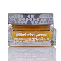  Organic gourmet mandarin jam with 85% fruit content, packaged in a glass jar with a label featuring geometric patterns.