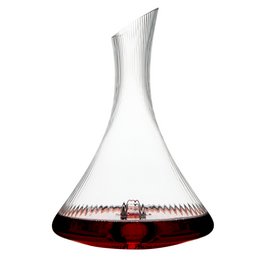 A tall, elegant glass decanter with a rounded body and a long, slender neck. The decanter has a dark red wine or liquid inside, creating a striking visual contrast with the clear glass. The decanter appears to be designed for serving and aerating wine.