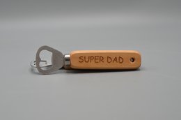 A wooden bottle opener with the text "SUPER DAD" engraved on it. This bottle opener is a functional and thoughtful gift for fathers.
