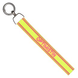  Beige woven keychain with pink "Bonjour" text, metal ring attachment, French-inspired bag charm accessory.