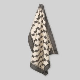 Handwoven ikat tea towel with a block pattern and a grey/ecru border.