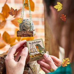 Organic gourmet pet treats in a natural, rustic packaging with a bird design.