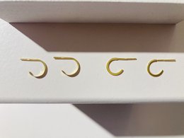 Small half hoop earrings made of 925 sterling silver with a gold finish.