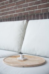 Hexagonal white candle holder with wooden base, featuring a modern, minimalist design suitable for home decor.