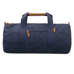 A navy blue weekend bag with white polka dots, featuring a cylindrical shape, leather handles, and a zipper closure.