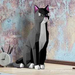 A black cat-shaped DIY craft kit made of geometric shapes and patterns. The cat has a sleek, angular design with pointed ears and a stylized appearance.