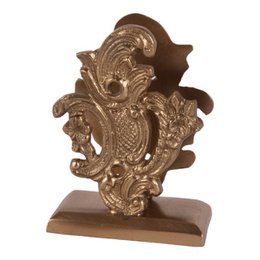 Brass card holder with ornate, swirling design. Suitable for holding business cards or other small items on a desk or table.