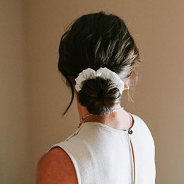 Soft, luxurious pure silk scrunchie in midnight blue, champagne, champagne rosé, and blanc colors. Elegant and versatile hair accessory.