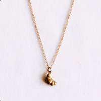 Delicate necklace with a mini croissant
