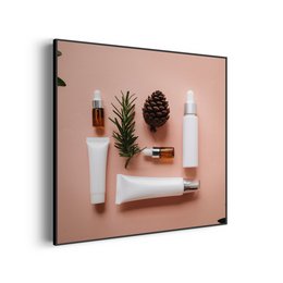 This image depicts a collection of beauty and skincare products, including a pine cone, a sprig of pine, and various bottles and jars. The products appear to be arranged on a pink background, creating a minimalist and aesthetically pleasing composition.