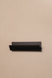 Large black sponge holder for kitchen storage.