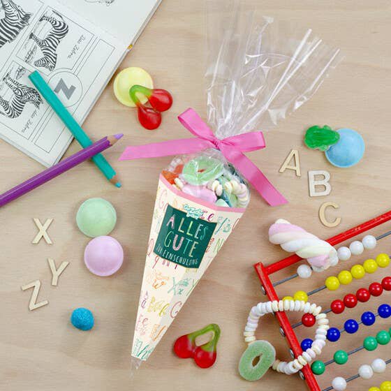 Sac de sucre inscription scolaire rose mélange de bonbons colorés