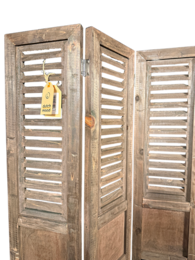 Green wooden shutters with horizontal slats, suitable for home decor.
