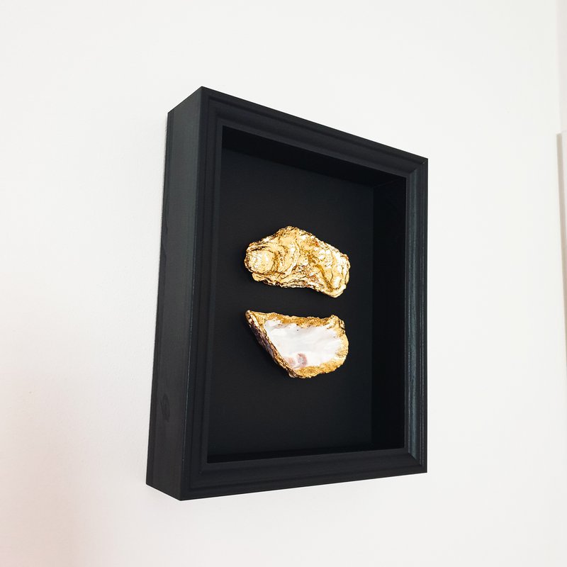 Double golden oysters in black wooden frame