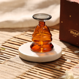 Amber glass bell, white ceramic base, decorative sculpture, minimalist design, luxury home decor.