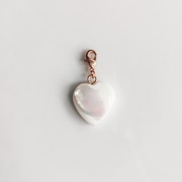 Elegant heart-shaped pendant with a pearlescent finish and a rose gold-tone clasp.