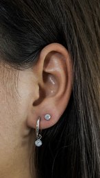Silver drop earrings with round black zirconia stones.