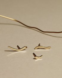 Three gold-colored stud earrings with a wave-like design.