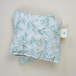Light blue cotton heating pad with delicate botanical leaf pattern, organic spelled filling.