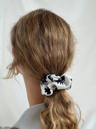 Light blue jacquard scrunchie made from recycled materials, available in mini and maxi sizes.