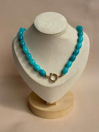 Turquoise beaded necklace with silver clasp, chunky barrel beads, statement jewelry piece.