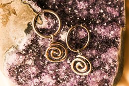  Silver hoop earrings with spiral designs, suitable for casual or formal wear.