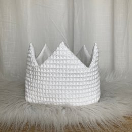 White waffle-textured crown-shaped party hat with pointed peaks, suitable for birthday celebrations.