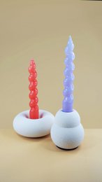 Fuzzy donut-shaped candle holders in red and white colors, with a soft, plush texture. Suitable for tea light candles.