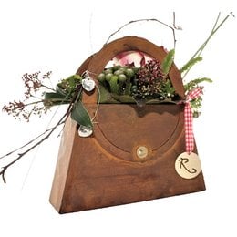 Decorative metal planter in a rustic, vintage-inspired design with a patina finish. Features a floral arrangement in a leather-like pouch. Available in 3 sizes.
The image shows a decorative metal planter with a rustic, vintage-inspired design and a patina finish. The planter is in the shape of a leather-like pouch or envelope, and it contains a floral arrangement inside. The product appears to be available in 3 different size variants.
Based on the details provided, the key product features that could be useful for a semantic search include:
- Material: Metal with a patina finish
- Style: Rustic, vintage-inspired
- Shape: Pouch or envelope-like
- Contents: Floral arrangement
- Sizes: 3 variants available