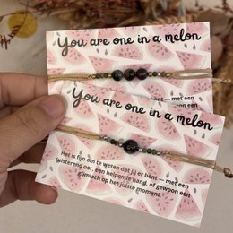 Beaded bracelet with watermelon-themed text and design. Includes round black and pink beads.