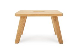 Robust oak wood stool "Emil" in warm honey finish. Sturdy and durable construction, suitable for use as a side table or footrest.