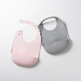 Two bibs in different colors - grey/aqua and light blue. The bibs have a simple, minimalist design with a snap closure at the neck.