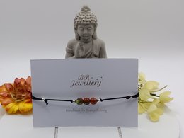 Bracciale con pietre preziose a flusso d'oro