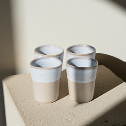 Espresso cups in a minimalist, cylindrical design with a neutral color palette.