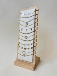 Gold delicate chain necklaces, pendant jewelry display stand, wooden base, minimalist elegant design.