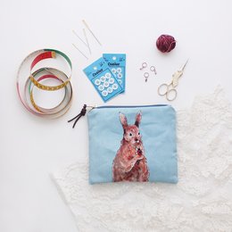  A small zipper pouch or clutch featuring a colorful illustration of a rabbit. The pouch is made of a durable fabric and is suitable for storing small items like coins, cards, or other personal belongings.