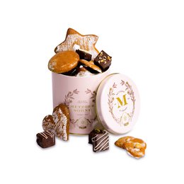 A pink tin container filled with assorted Lebkuchen, a traditional German gingerbread-like cookie. The tin features a decorative floral design. The Lebkuchen pieces inside the tin are in various shapes, including stars and other festive forms, and appear to be coated in a chocolate or glaze.
