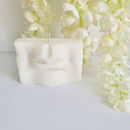 Cream-colored, round, tall candle with a simple, minimalist design.