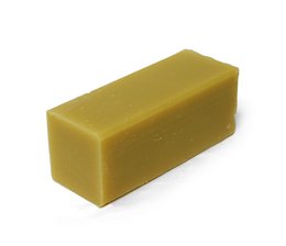 Large rectangular bar of natural almond and avocado soap, with a smooth, creamy yellow color.