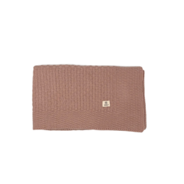 Soft, square baby blanket in a warm pink color. Made of cozy, ribbed knit material for comfort and style.