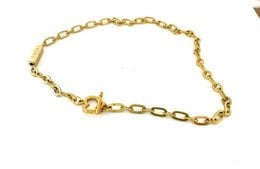 Gold-tone necklace with charms featuring the words "Free", "Angel", "Devil", and "Faith" on a chain with oval links.