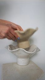 A handmade, matte gray vase with a simple, cylindrical shape.