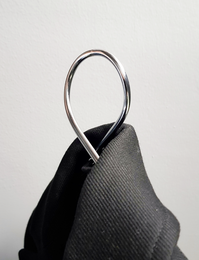 Chrome metal hangers with a loop design for hanging clothes.