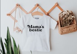 White kids t-shirt with "Mama's Bestie" text printed on the front. Available in sizes from 0-3 months to 12-13 years.