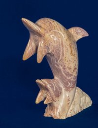 Soapstone dolphin statue with mother and baby, featuring a carved design with natural textures and a sleek, rounded shape.
