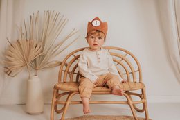 A rust-colored felt crown with a number 1 printed on it, suitable for a child's birthday celebration.