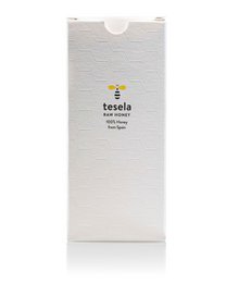A white gift box with the Tesela logo printed on the front. The box appears to be made of a sturdy, textured material, possibly cardboard or a similar material. The box has a simple, minimalist design that would be suitable for packaging a variety of gift items.